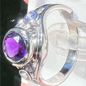 Ring- Rhodium Over
Sterling Silver 
1.13 CTW Amethyst
0.14 CTW Tanzanite 
Size 7